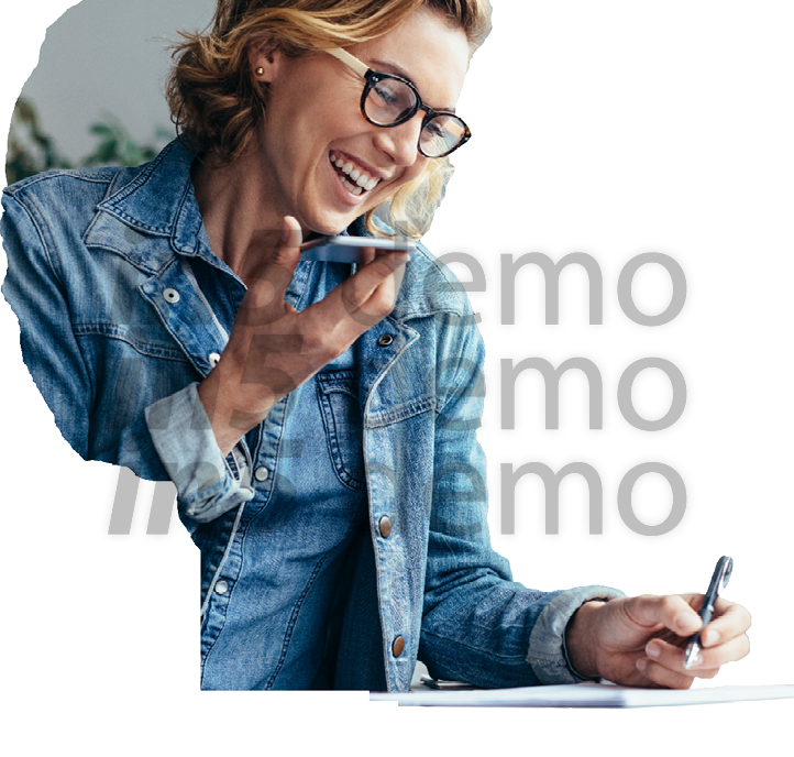 Young female executive working in office  Smiling young businesswoman talking on cellphone and writing notes 